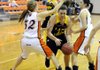 Prairie Grove senior Alex Myers, center, tries to get past Gravette’s Shelby Newell, right, and Jacy Alsup in the fourth quarter Friday in Gravette.