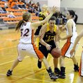 Prairie Grove senior Alex Myers, center, tries to get past Gravette’s Shelby Newell, right, and Jacy...