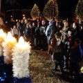 Etz Chaim synagogue’s cantor Debbye Zanerhaft, left, leads a crowd in singing blessings over a light...