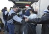 Volunteers load a vehicle with presents Friday during the Sharing and Caring of Benton County distribution day at the Benton County Fairgrounds. The charity organization provided gifts for more than 5,000 children.