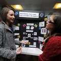 Megan Sanders, left, a ninth-grader at Haas Hall Academy talks Friday to Jeana Monrad about her scie...