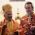 Bishop Antoun Khouri of the Diocese of Miami and the Southeast, left, consecrates the new St. Nichol...