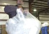 Superintendent Jerrold Haley recycles packing foam at the Rogers Recycling Center. A machine crushes the foam and turns it into blocks.