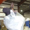 Superintendent Jerrold Haley recycles packing foam at the Rogers Recycling Center. A machine crushes...