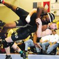 Bentonville’s Jason Bruno, right, takes Little Rock Central’s Marcus Williams to the mat during thei...