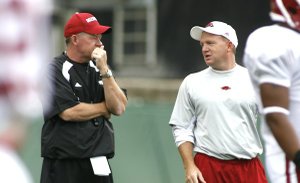 Arkansas offensive coordinator Paul Petrino, right, left the Razorbacks and brother Bobby Petrino, left, to become the offensive coordinator at Illinois on Dec. 14.
