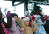 The St. Vincent de Paul Middle School Choir of Rogers sings “Hot Chocolate” Saturday morning during their performance at WinterFest on the Frisco Stage in downtown Rogers. Gabby Agcaoili, from left, Mary Fretland and Jordan Gall toss their hot chocolate cups backstage at the end of the song. WintertFest featured stage performances, horse and carriage rides and vendors selling a variety of holiday goods on the downtown streets.