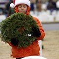 Eli Conley, 7, of Fayetteville prepares to place a holiday wreath Saturday on a headstone at the Fay...