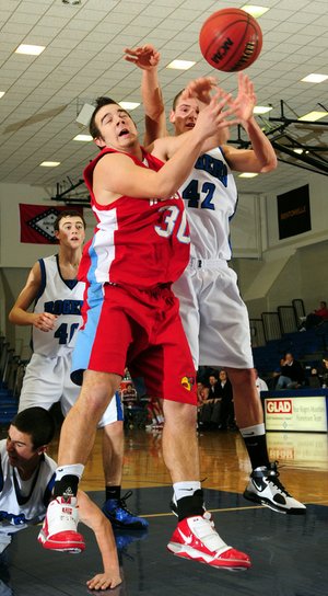 Rogers’ Graham Parker, right, fights for a rebound with Webb City’s Phil Donna on Saturday during the championship game in the Arvest Hoopfest at Rogers High School.