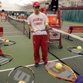 Bradwin Williams, an Arkansas tennis player, works with children Dec. 6 during Kid’s Tennis Day at t...