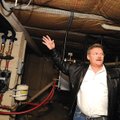Calvin Yockey shows the inner workings of his geothermal system in his Fayetteville house.