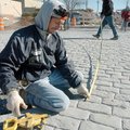 Frank Gonsalves with Ozark Patterned Concrete takes measurements Friday at the intersection of Secon...