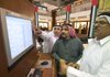 Investors monitor share prices Monday at the Dubai Financial Market in the United Arab Emirates. 