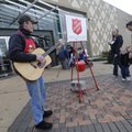 Lawrence Haynes of Fayetteville plays a guitar Monday while working as a Salvation Army bell ringer ...