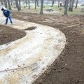 Jorge Gonzalez, an employee of Fayetteville Parks and Recreation, smoothes soil after planting grass...