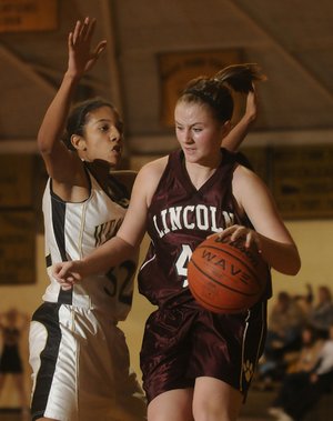Lincoln’s Rashelle Goldman drives to the basket as West Fork’s Melissa Jones defends during Monday’s nonconference game in West Fork.