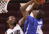 UALR’s Wayne Burton (left) blocks a shot by Memphis’ Elliot Williams during Saturday night’s game. The Trojans will try to get back on the winning track tonight in their Sun Belt Conference opener against South Alabama. 