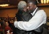 Former NBA basketball player Larry Johnson hugs former University of Arkansas basketball coach Nolan Richardson after speaking Tuesday at the Northwest Arkansas Tip-Off Club luncheon at the Springdale Holiday Inn.
