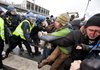  	Danish riot police push back protestors, one bleeding, at right, during a demonstration outside the Bella Center, the venue of the U.N. climate change conference, in Copenhagen on Wednesday, Dec. 16, 2009. 