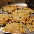 Members of Congregation Etz Chaim in Bentonville fry pans of potato latkes on Friday for their Pot L...