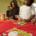 Conley Harper, left, and Kennedy McCoy make cookies Tuesday during a Christmas party for children in...