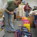 Christina Lisle, left, and Roger Calvert, background right, load gift bags for students at Jones Ele...
