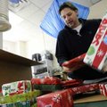 Todd Thomas packs a customer’s Christmas gifts into a box for shipment to Ohio on Wednesday at Bento...
