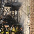 Fayetteville firefighters cut a vent hole Wednesday in the wall of an apartment building at The Vine...