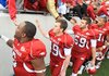 Arkansas deep snapper Rhett Richardson, third from left, and his teammates shake hands with fans following the Mississippi State game Nov. 21 in Little Rock. 