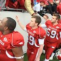 Arkansas deep snapper Rhett Richardson, third from left, and his teammates shake hands with fans fol...