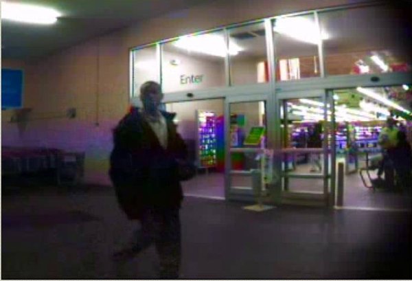 a-photo-taken-from-a-security-camera-shows-an-unidentified-man-at-the-entrance-of-the-sherwood-wal-mart-the-man-is-accused-of-running-off-with-the-salvation-army-bucket