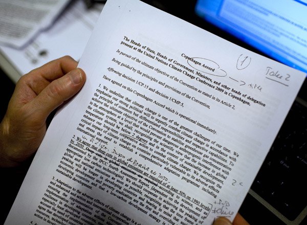 a-journalist-reads-the-latest-draft-of-the-copenhagen-accord-at-the-climate-summit-in-copenhagen-denmark-friday