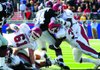 Arkansas linebackers Wendel Davis, right, and Jerry Franklin try to stop running back Brandon Bolden at the line of scrimmage Oct. 24 in Vaught-Hemingway Stadium in Oxford, Miss.
