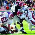 Arkansas linebackers Wendel Davis, right, and Jerry Franklin try to stop running back Brandon Bolden...