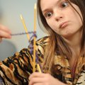 Katelynn Tubbs, 13, of Fayetteville is puzzled while learning to knit Thursday at the Fayetteville P...