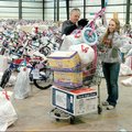 A full cart Salvation Army volunteers Richard Kuehl of Springdale and Jenna Waselues of Fayetteville...