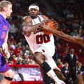 Arkansas' Mike Washington drives between Stephen F. Austin's Will Reinke (34) and Walt Harris (4) Sa...