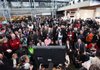 Climate summit delegates and journalists crowd around a television Friday in Copenhagen to hear President Barack Obama announce a five-nation agreement on curbing greenhouse gases. Obama added that hammering out a legally binding global treaty will be “very hard.”