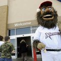 Strike, the Northwest Arkansas Naturals mascot, greets customers Thursday entering Sam’s Club while ...