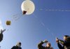 LAUNCH AND LEARN
Taylor Parks, 15, right, holds onto a tether line Friday while preparing to launch a weather balloon with Northwest Technical Institute instructor Mark Huffman, second right, and students Cody Johnson and Phillip Stewart at Crossroads Alternative School in Rogers.
