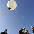 LAUNCH AND LEARN
Taylor Parks, 15, right, holds onto a tether line Friday while preparing to launch...