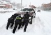 Police officers aid a motorist Saturday in Waynesboro, Va., where a winter storm crippled travel.