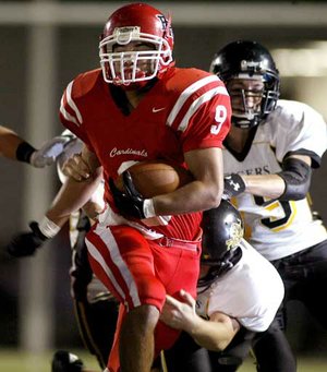 Farmington’s Jared Martin tries to break free from a Prairie Grove tackler during the first quarter of an Oct. 2 game in Farmington.