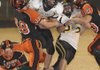 Praire Grove running Back Thomas Soehner tries to break free from Gravette linebacker Nick Hendren, left, while Steven Thomas attempts to block Gravette defensive lineman Travis Eden on Nov. 6 in Gravette.