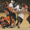 Praire Grove running Back Thomas Soehner tries to break free from Gravette linebacker Nick Hendren, ...
