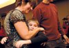 Teena Webster of Fayetteville, left, and her husband, Jeff, meet Austin Taylor, 9, of Gurdon for the first time Saturday. Taylor received a kidney from the Websters’ son, Aaron, who was killed in an automobile accident Sept. 5.
