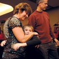 Teena Webster of Fayetteville, left, and her husband, Jeff, meet Austin Taylor, 9, of Gurdon for the...