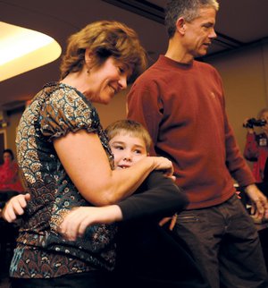 Teena Webster of Fayetteville, left, and her husband, Jeff, meet Austin Taylor, 9, of Gurdon for the first time Saturday. Taylor received a kidney from the Websters’ son, Aaron, who was killed in an automobile accident Sept. 5.