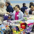 Volunteer Abby Shoffmer, 12, center, helps Marion Nance, left, shop for toys for her two grandchildr...