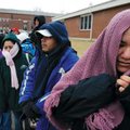 Lucia Estrada, right, Angelo Andrade, Doris Argueta and Roxana Comstanza wait in line in below freez...